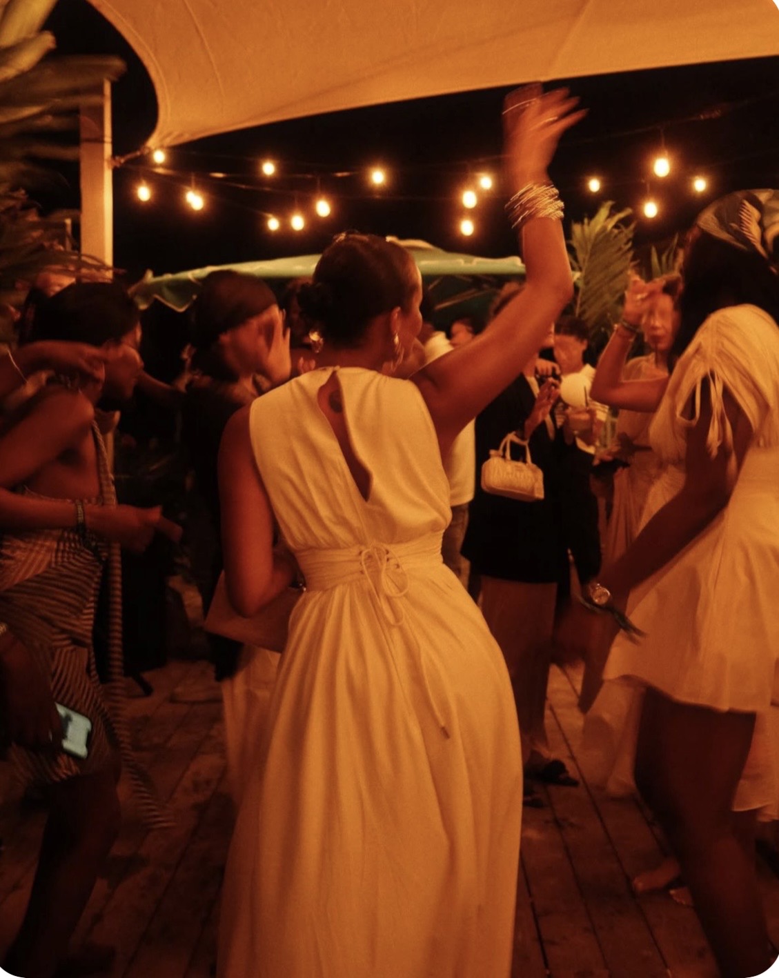 Outdoor dance party under string lights