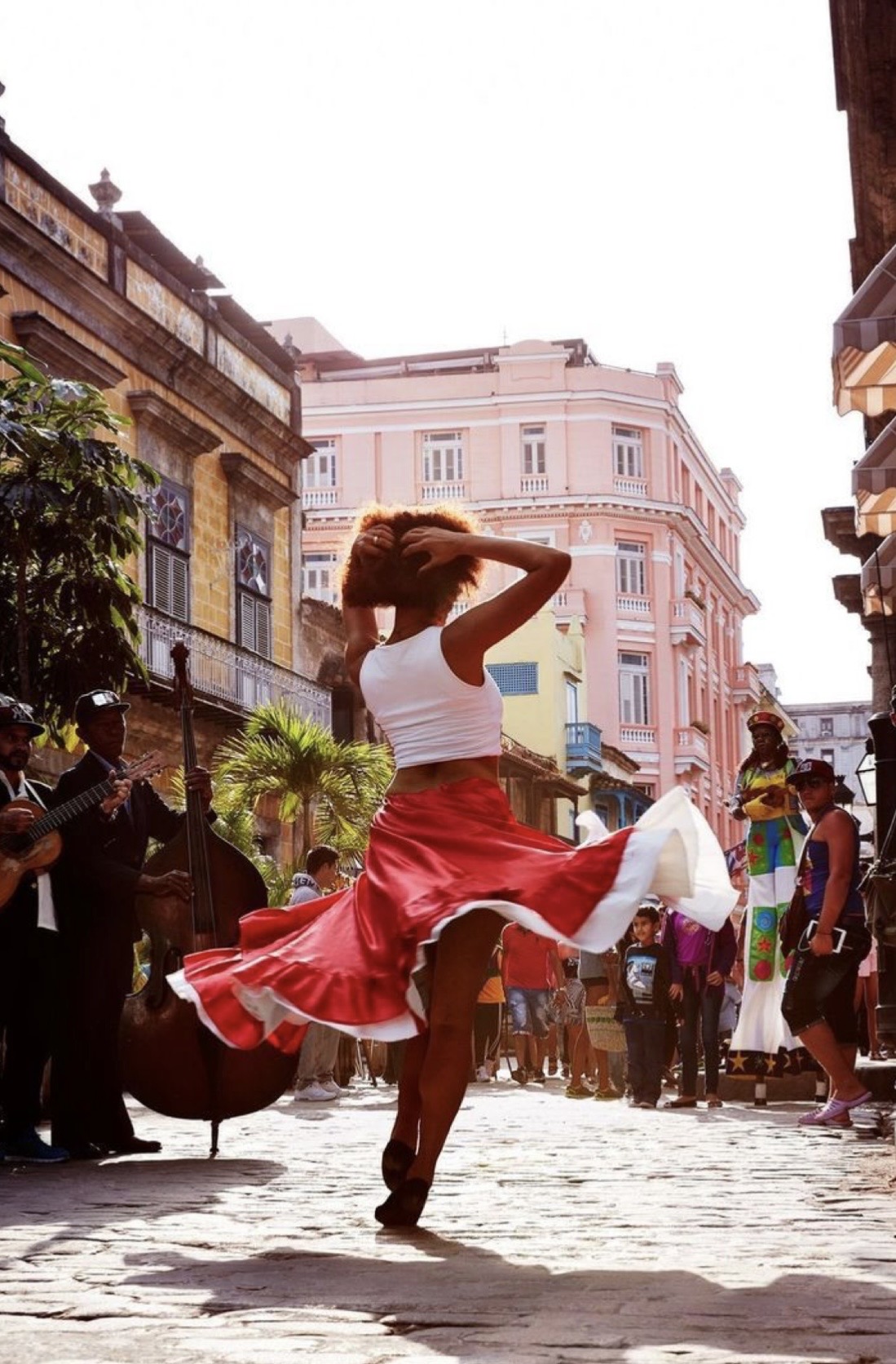 Cuban dancer spinning in red skirt on Havana street