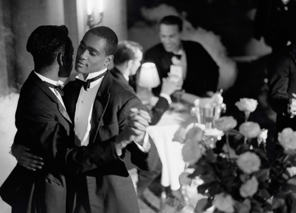 Black and white tuxedoed couple slow dancing