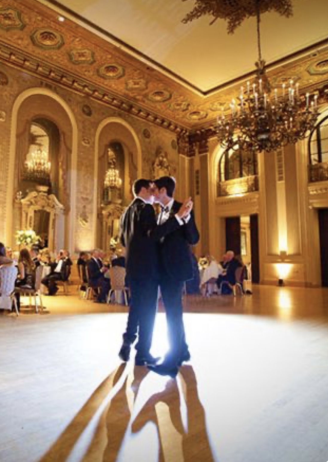 Couple dancing in a grand gilded ballroom