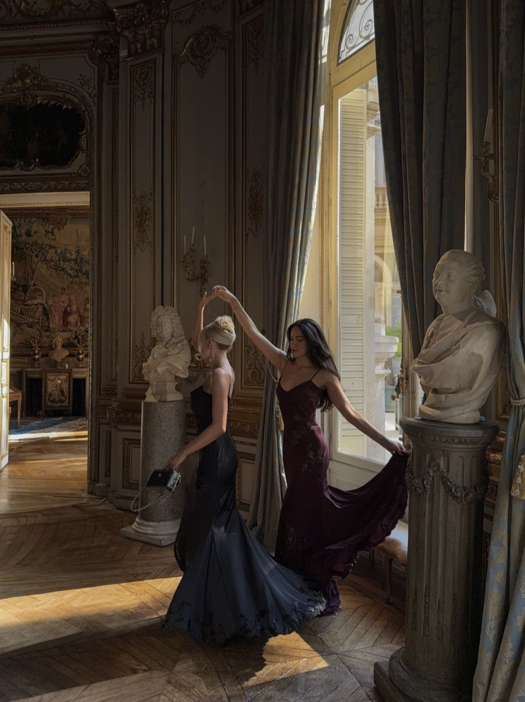 Elegant gowned dancers in a Parisian salon