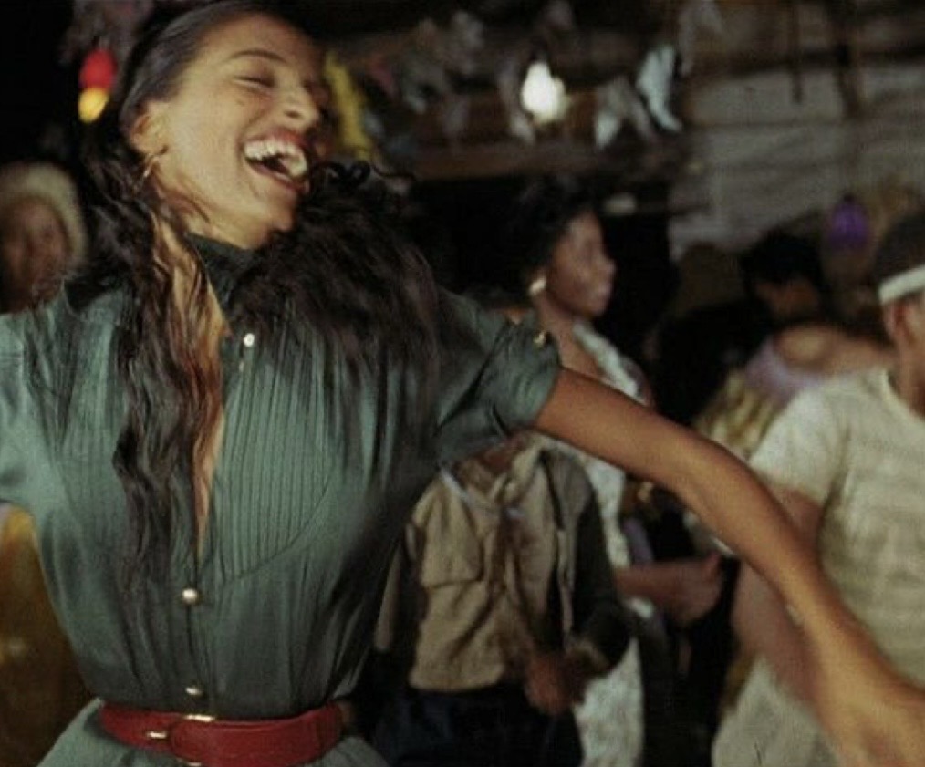 Joyful woman laughing mid-dance in vintage scene