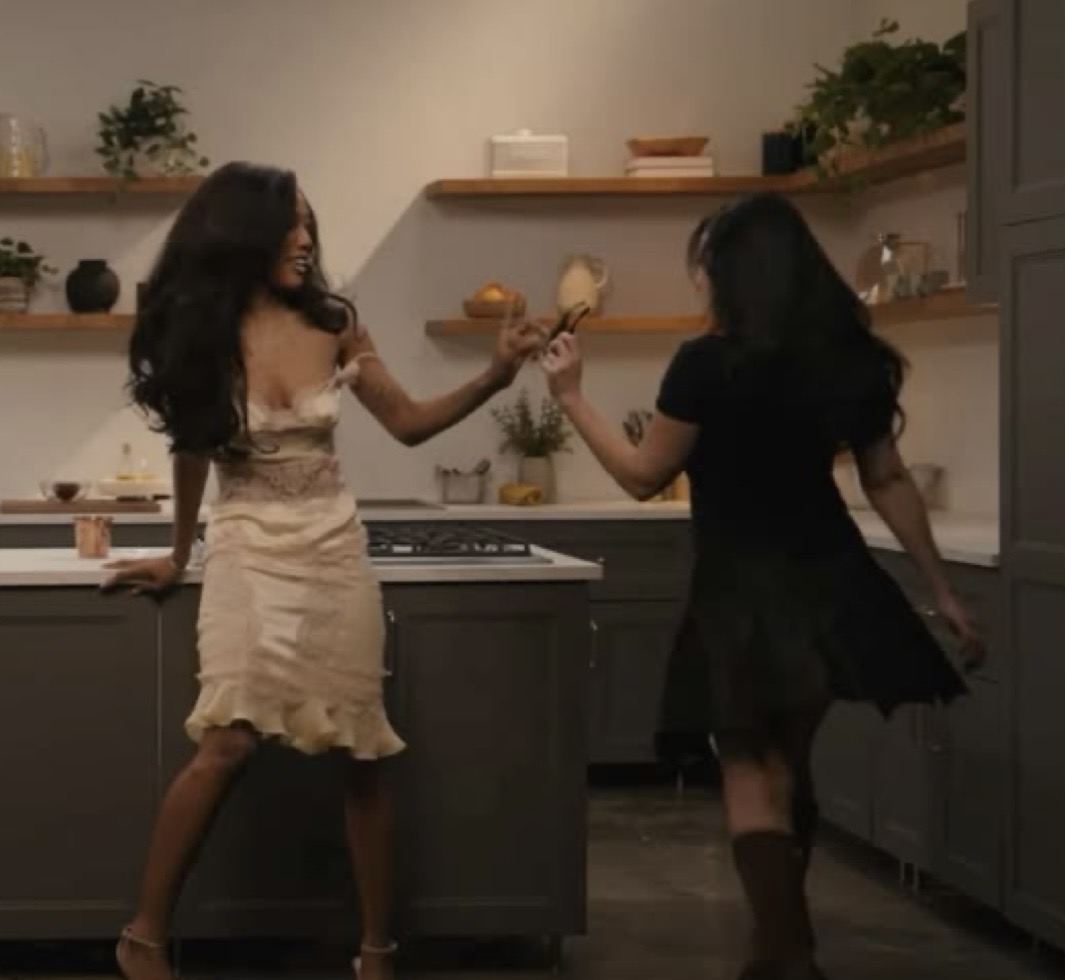 Two friends dancing in a kitchen