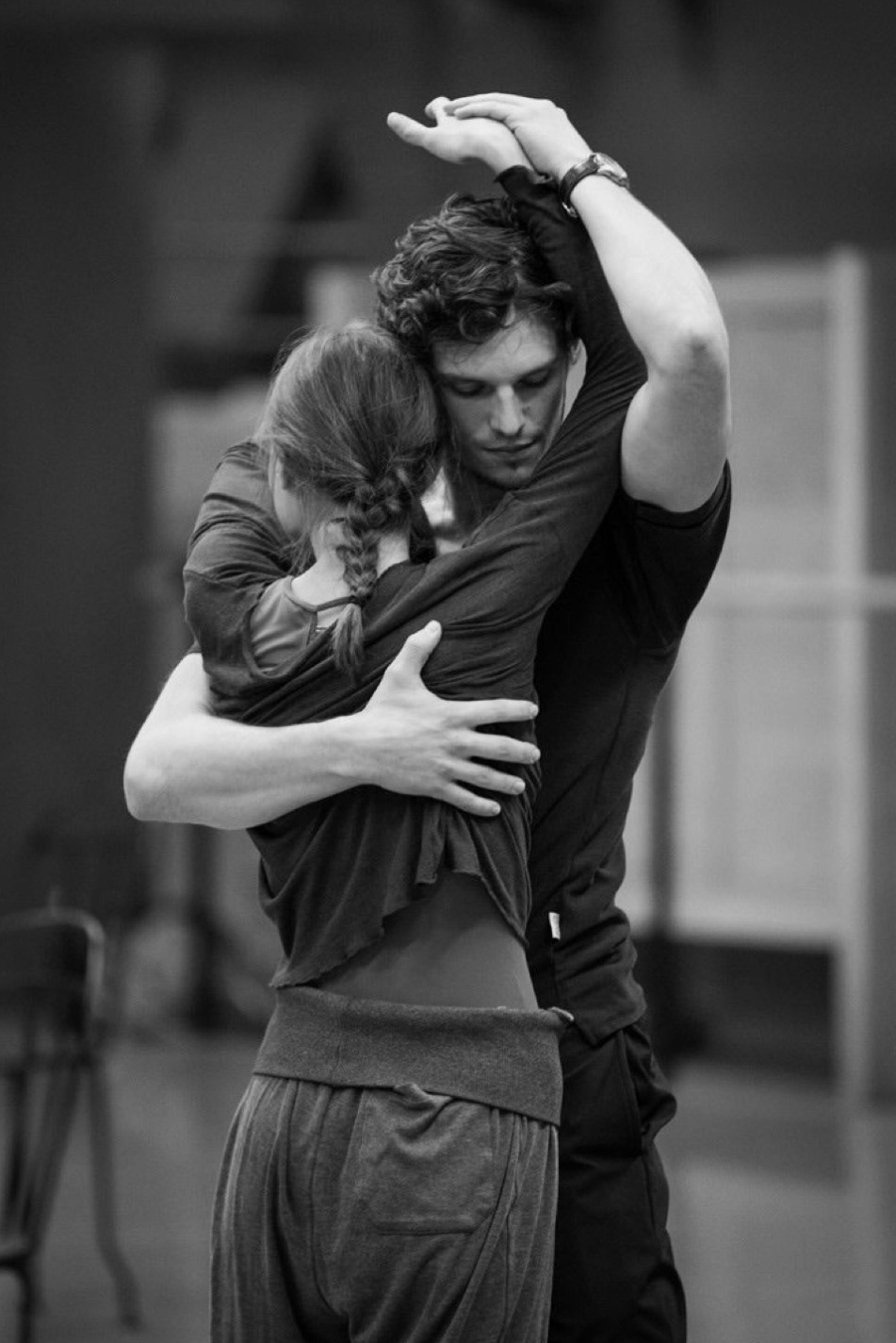 Contemporary dance partners in studio embrace