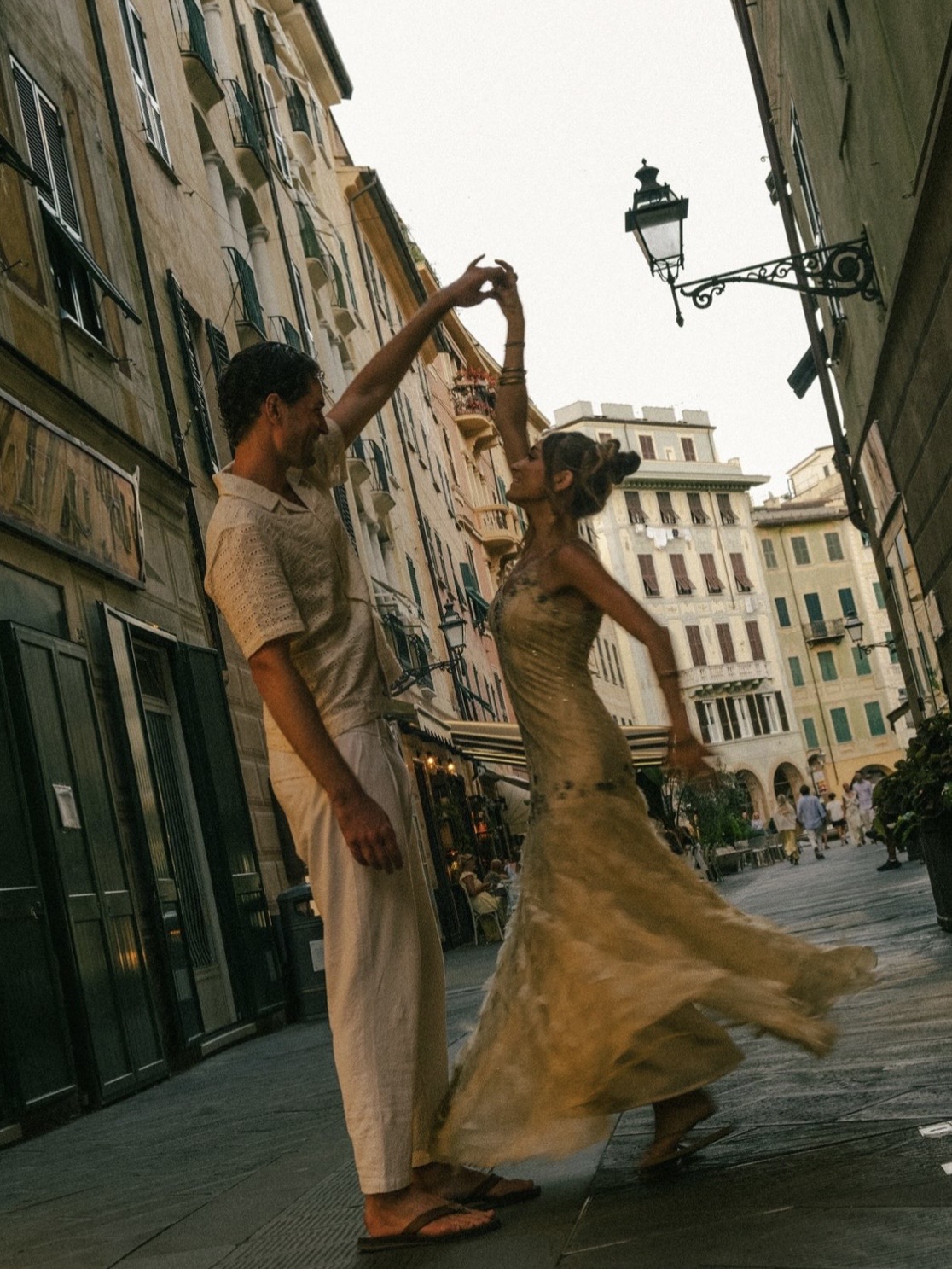 Couple dancing gracefully on an Italian street at golden hour