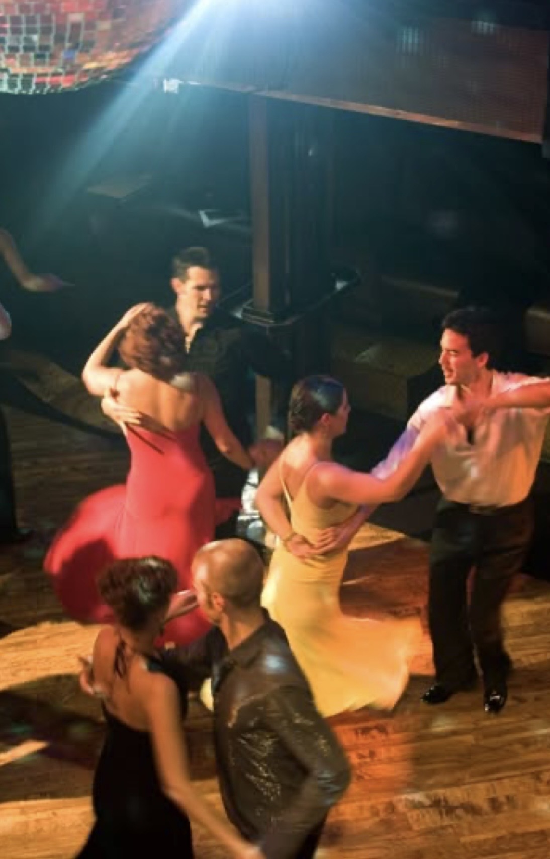 Ballroom dancers spinning in red and gold