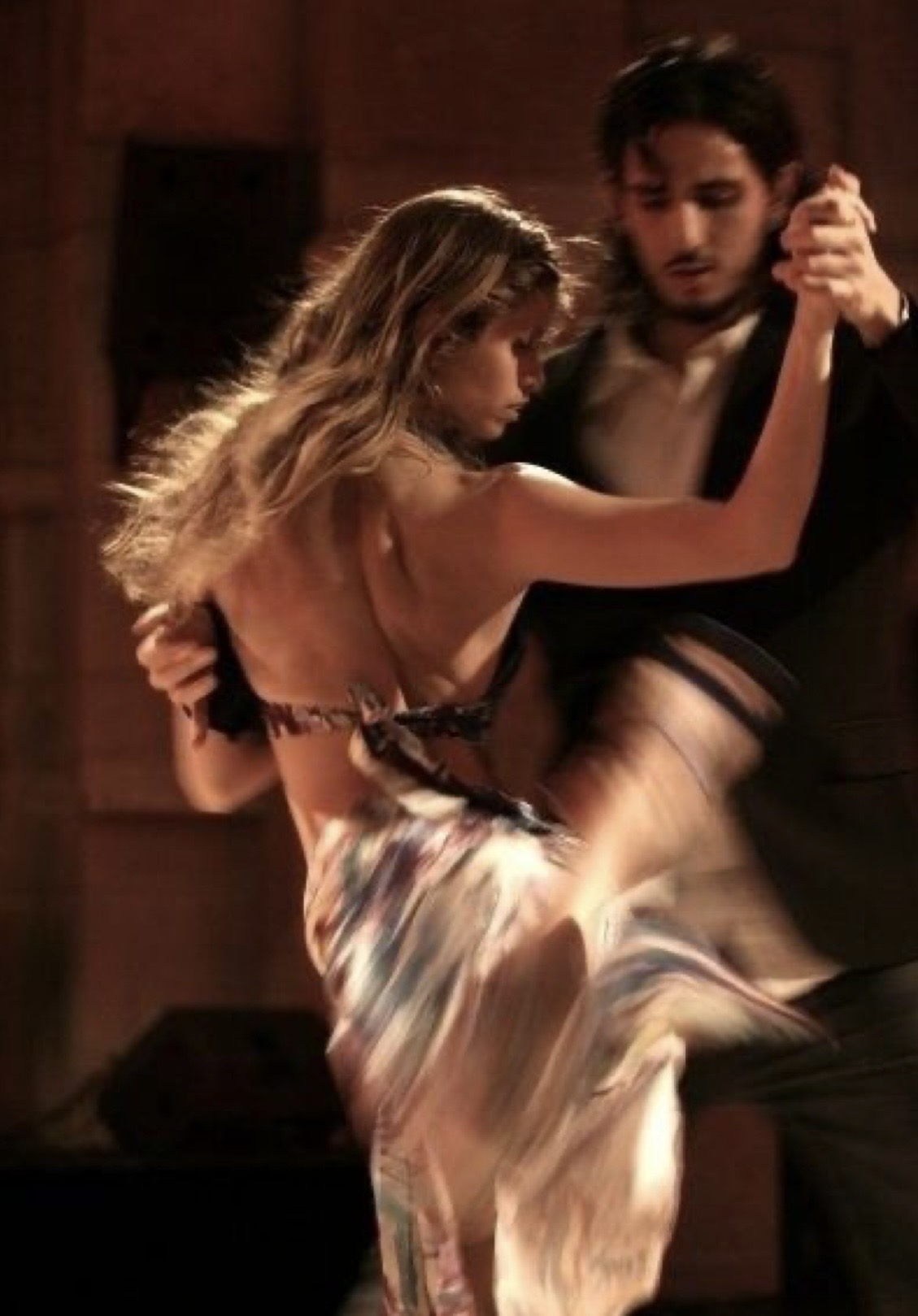 Sweeping tango embrace with flowing skirt